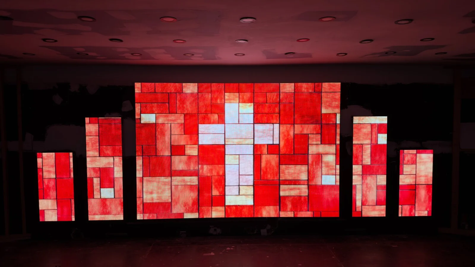 AlturaLED stage set with a red cross graphic